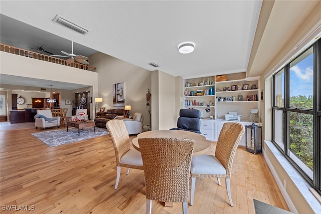 dining area featuring light wood-type flooring and ceiling fan