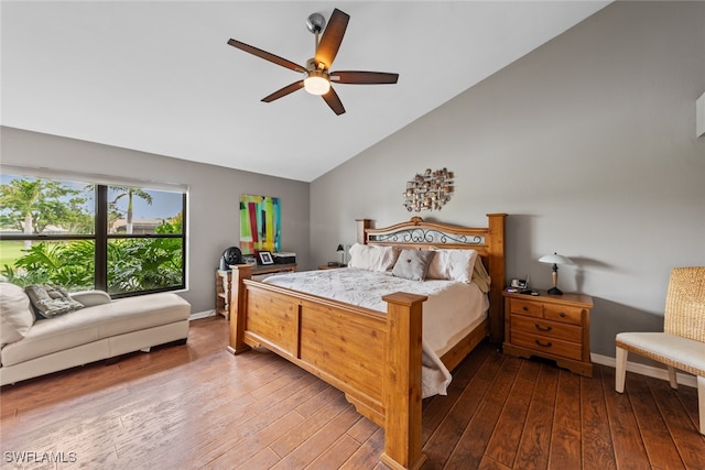 bedroom with hardwood / wood-style floors, ceiling fan, and vaulted ceiling