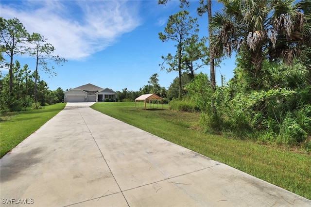 view of front facade featuring a garage, a front lawn, and a gazebo