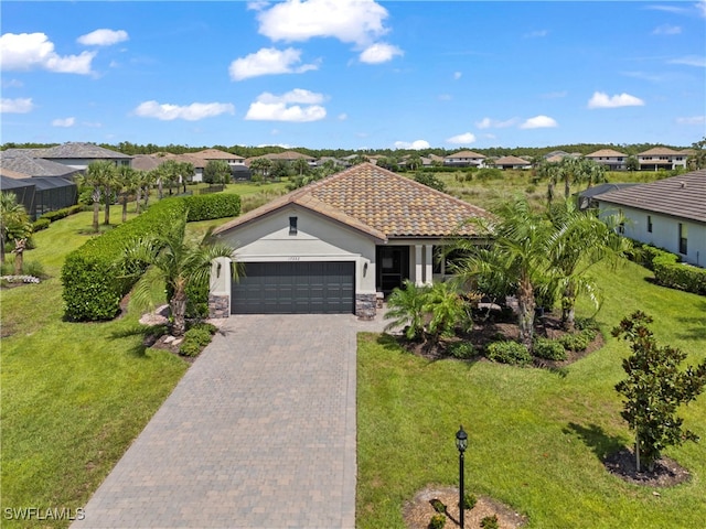 view of front of house with a front yard and a garage