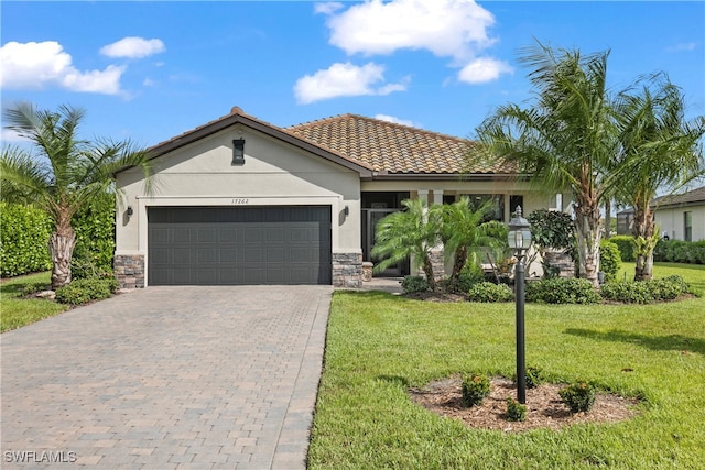 view of front of property featuring a garage and a front lawn