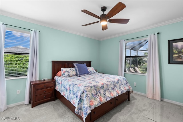 carpeted bedroom with ceiling fan and crown molding