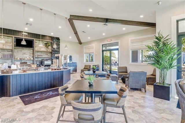 dining area featuring french doors and lofted ceiling with beams