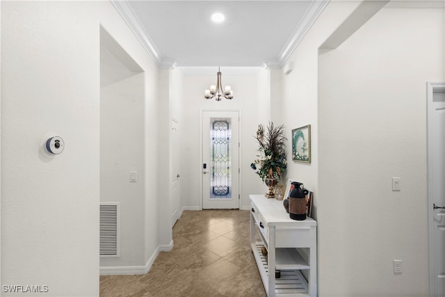 foyer entrance with light tile patterned floors, an inviting chandelier, and crown molding