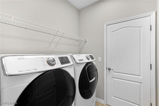 washroom with washing machine and clothes dryer