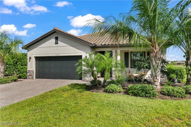 mediterranean / spanish-style home with a front yard and a garage