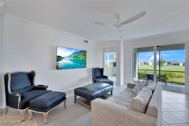 living room with crown molding, light tile patterned flooring, and ceiling fan