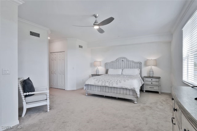 bedroom with ceiling fan, a closet, light carpet, and ornamental molding