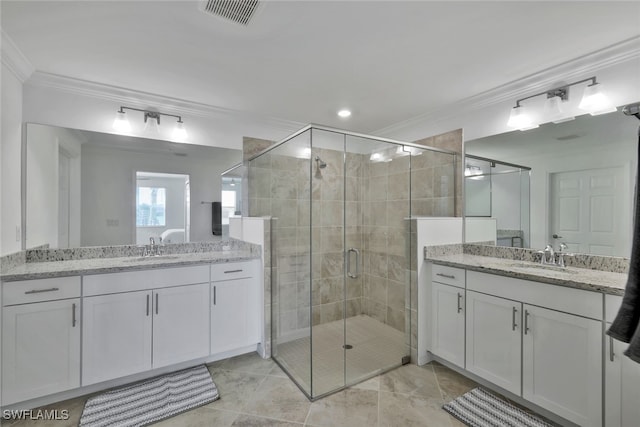 bathroom with vanity, ornamental molding, and walk in shower