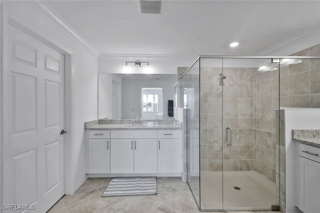 bathroom featuring crown molding, a shower with door, and vanity