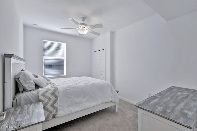 bedroom with light carpet, a closet, and ceiling fan