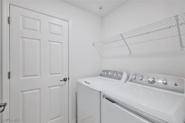 clothes washing area with separate washer and dryer