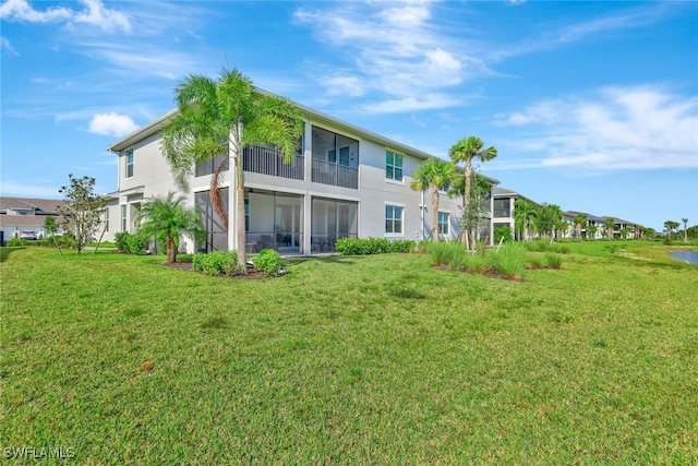 rear view of property featuring a lawn