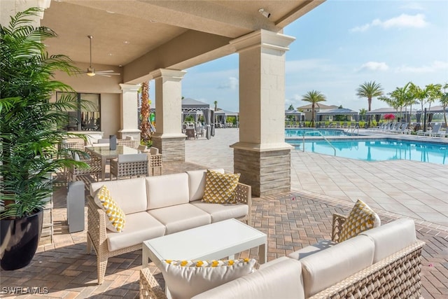 view of patio / terrace featuring a community pool and outdoor lounge area