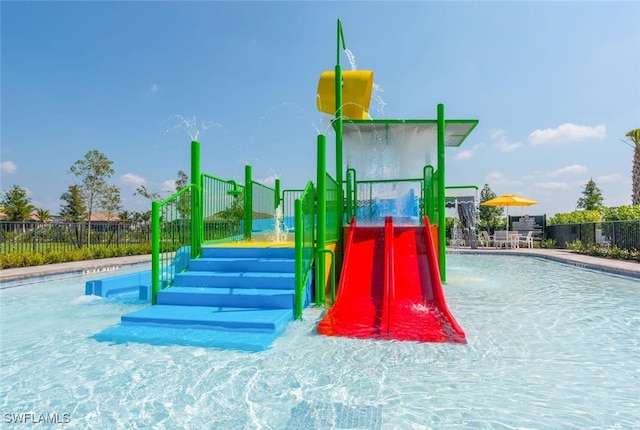 view of jungle gym featuring pool water feature and a community pool