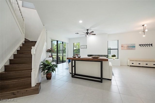 interior space featuring light tile patterned floors and ceiling fan