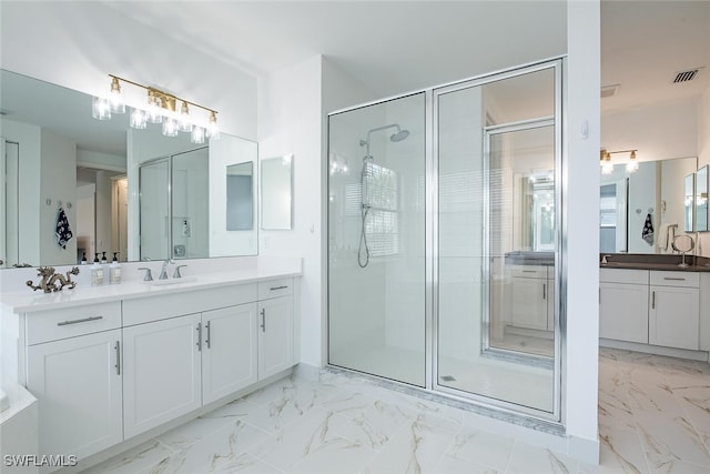 bathroom featuring an enclosed shower and vanity