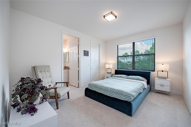 carpeted bedroom featuring connected bathroom