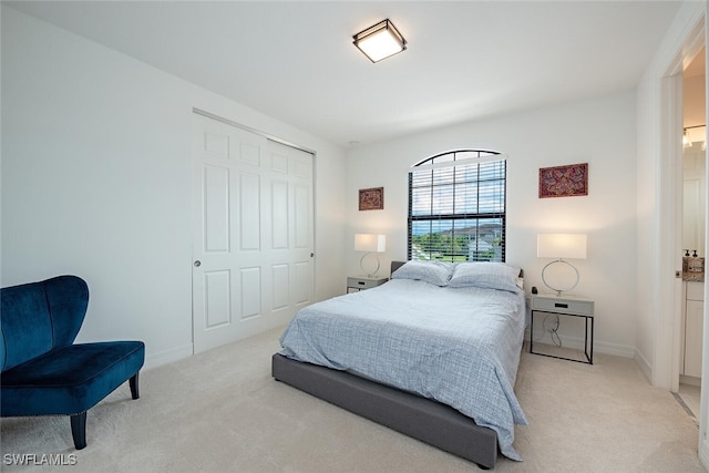 bedroom featuring a closet and light carpet