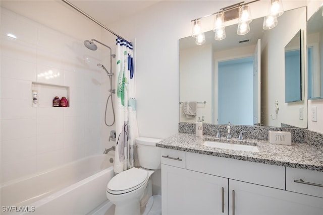 full bathroom with vanity, shower / bath combo with shower curtain, and toilet