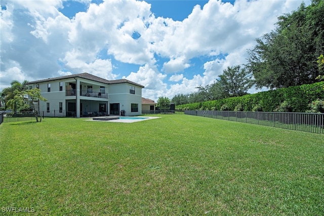 view of yard with a balcony and a patio