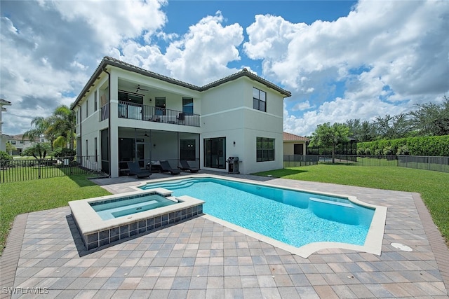 view of pool featuring an in ground hot tub, a lawn, and a patio