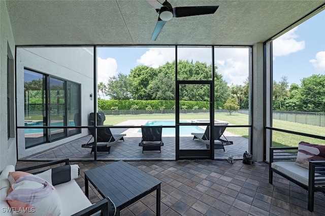 sunroom featuring ceiling fan and a wealth of natural light