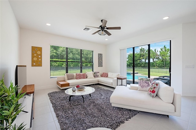 living room featuring light tile patterned floors and ceiling fan