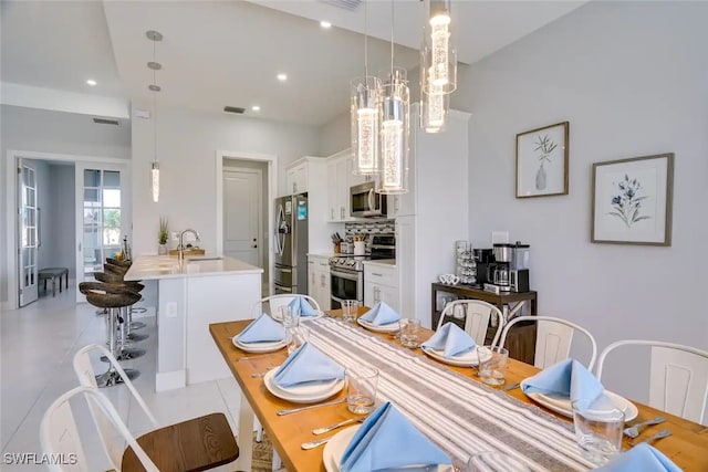 dining area with light tile patterned floors and sink