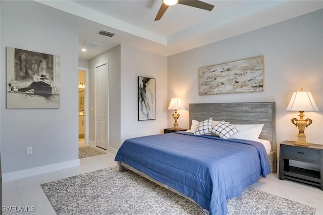 bedroom with light tile patterned floors, a closet, ensuite bathroom, and ceiling fan