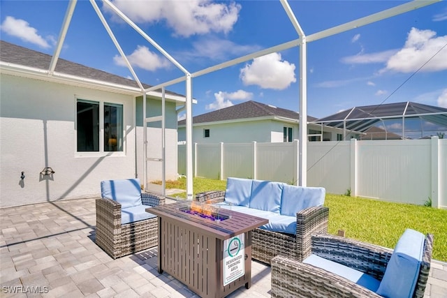 view of patio featuring a lanai and an outdoor fire pit