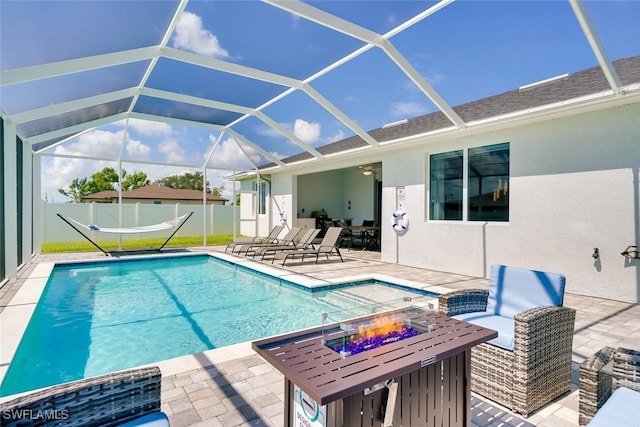 view of pool with a patio, a fire pit, and a lanai