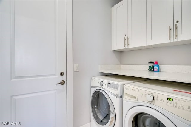 washroom with cabinets and independent washer and dryer