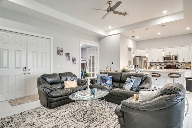 living room featuring ceiling fan and light tile patterned flooring