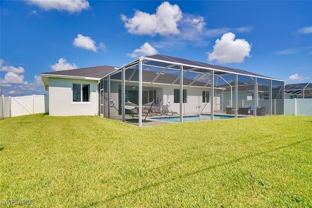 back of house with a patio, a yard, a fenced in pool, and glass enclosure