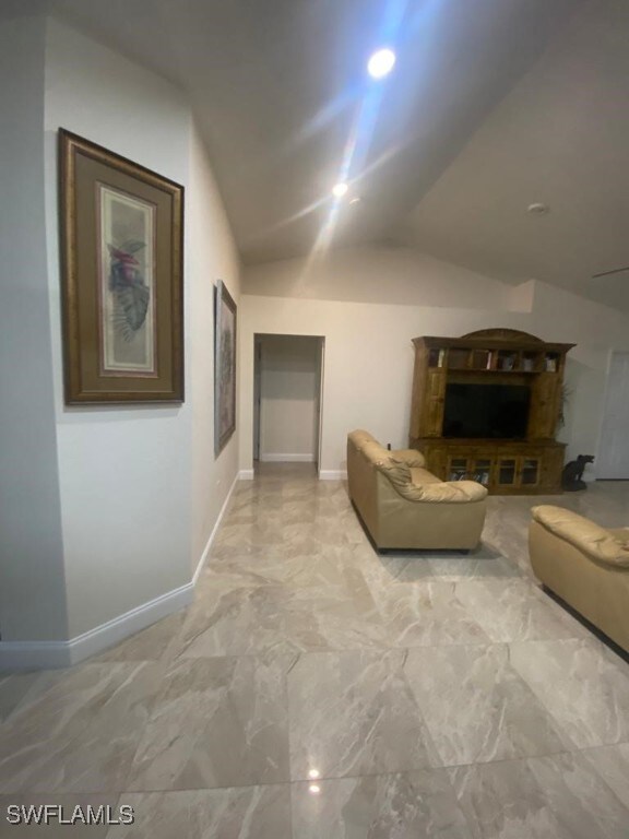 unfurnished living room with vaulted ceiling