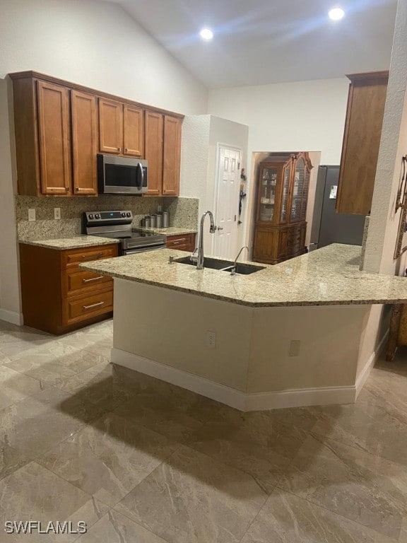 kitchen featuring kitchen peninsula, appliances with stainless steel finishes, backsplash, high vaulted ceiling, and light stone countertops