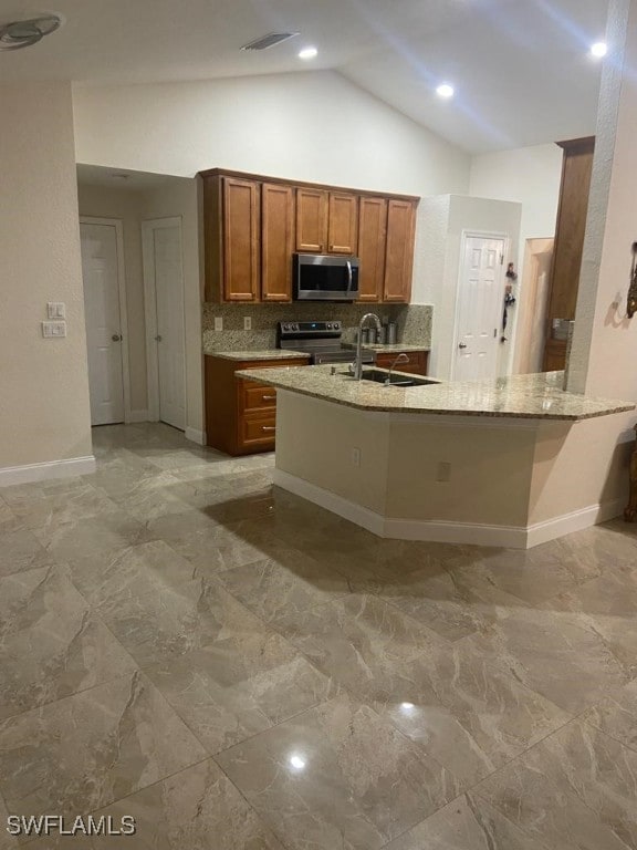 kitchen featuring stainless steel appliances, decorative backsplash, sink, high vaulted ceiling, and light stone counters