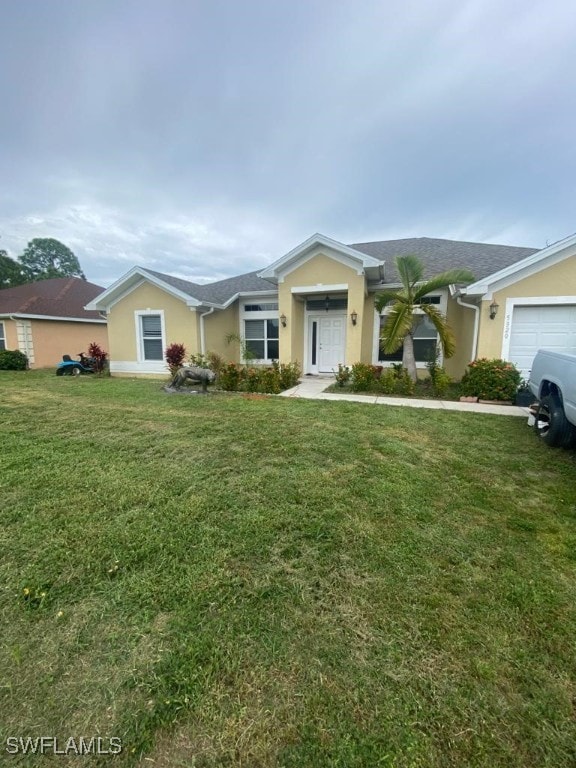 ranch-style home with a garage and a front yard