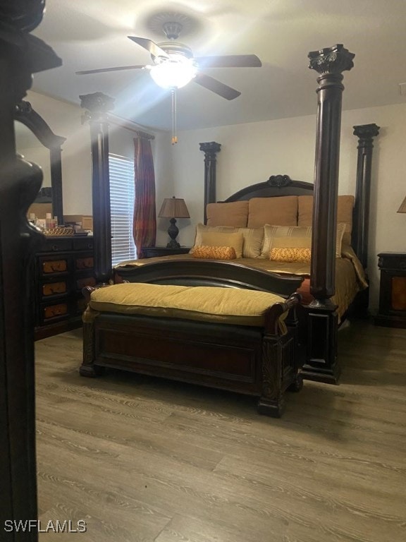 bedroom with ceiling fan and wood-type flooring