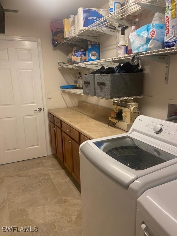 washroom with washing machine and clothes dryer