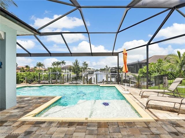 view of pool featuring glass enclosure, a boat dock, and a water view