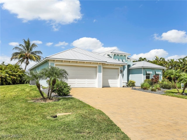 view of front of home featuring a garage and a front yard