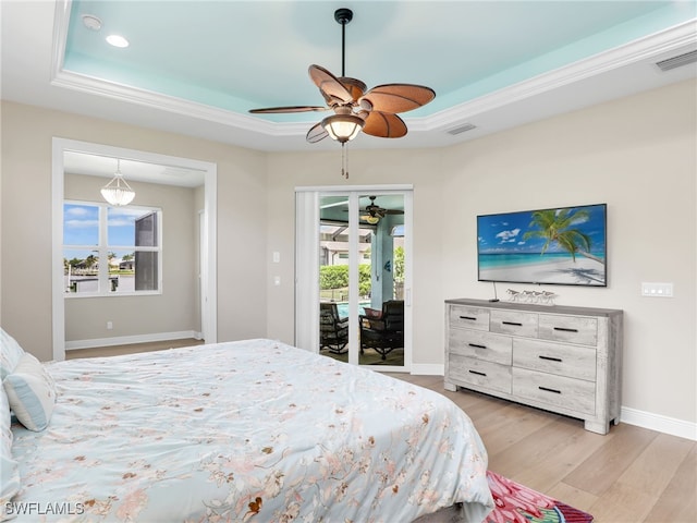 bedroom featuring ceiling fan, crown molding, light hardwood / wood-style floors, a raised ceiling, and access to exterior