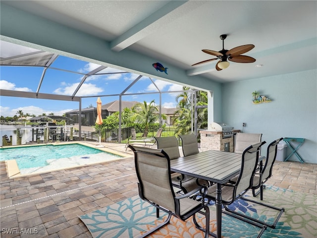 view of pool with exterior kitchen, a patio area, ceiling fan, a lanai, and area for grilling