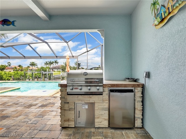 view of patio / terrace featuring area for grilling, a lanai, and grilling area