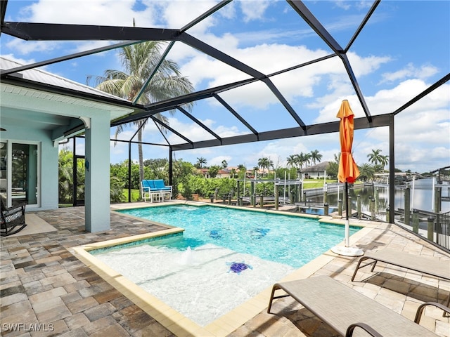 view of swimming pool featuring pool water feature, a water view, a lanai, and a patio area