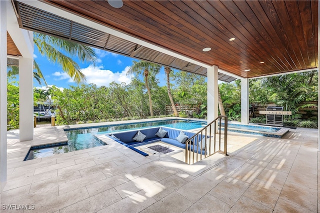 view of pool with a patio area, an in ground hot tub, and an outdoor fire pit