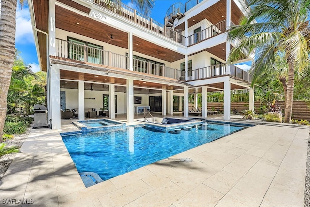 view of pool featuring ceiling fan, a patio area, and an in ground hot tub