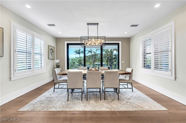 dining area with a chandelier and hardwood / wood-style flooring